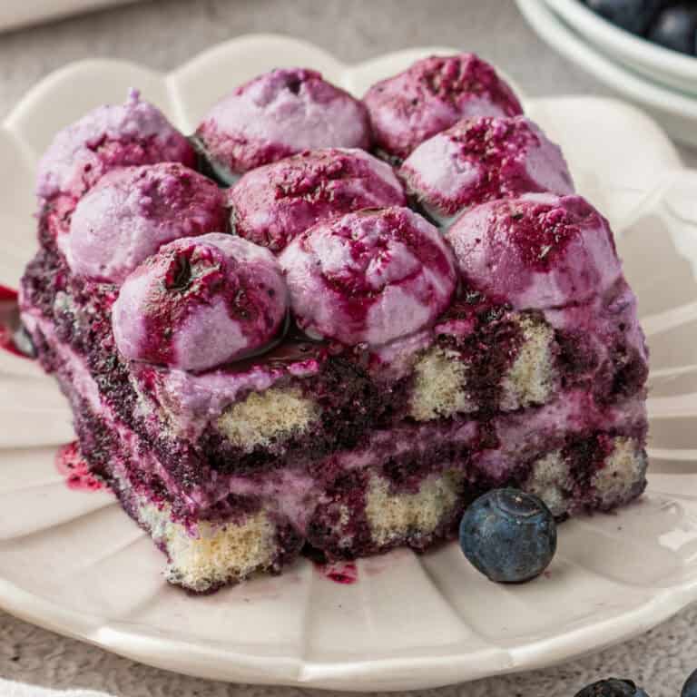 A slice of Blueberry Tiramisu on a white plate.