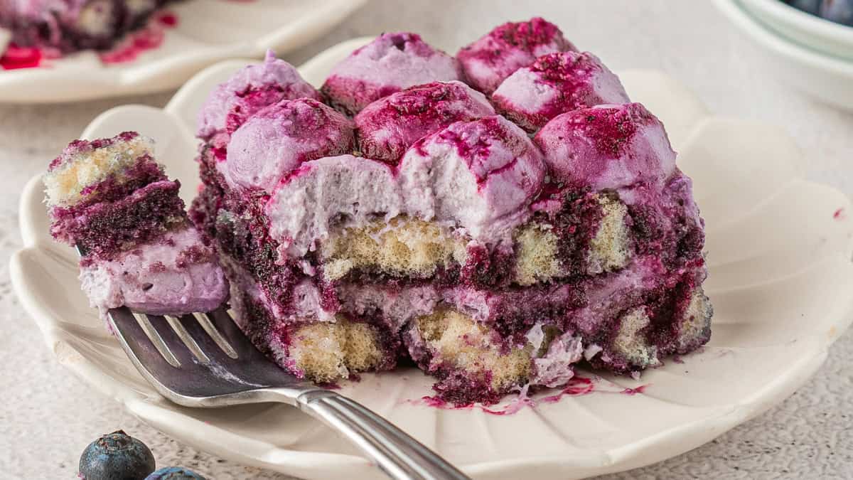 Blueberry Tiramisu - a Summer Version of the Classic Italian Dessert! A slice of Blueberry Tiramisu on a white plate.