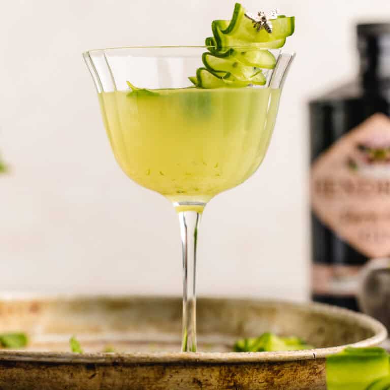 Cucumber Gimlet Cocktail in a glass garnished with a cucumber ribbon.