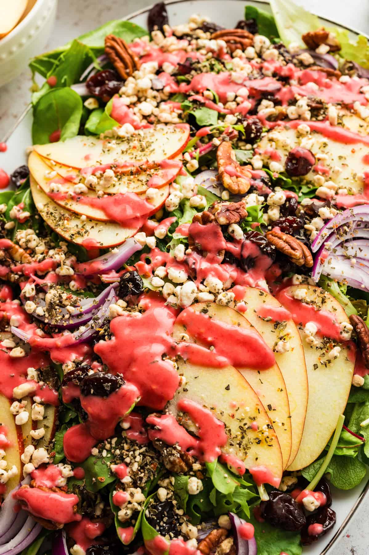 Simple Green Salad with Apples and Raspberry Vinaigrette Simple Green Salad with Apples and Raspberry Vinaigrette - on a large white platter.
