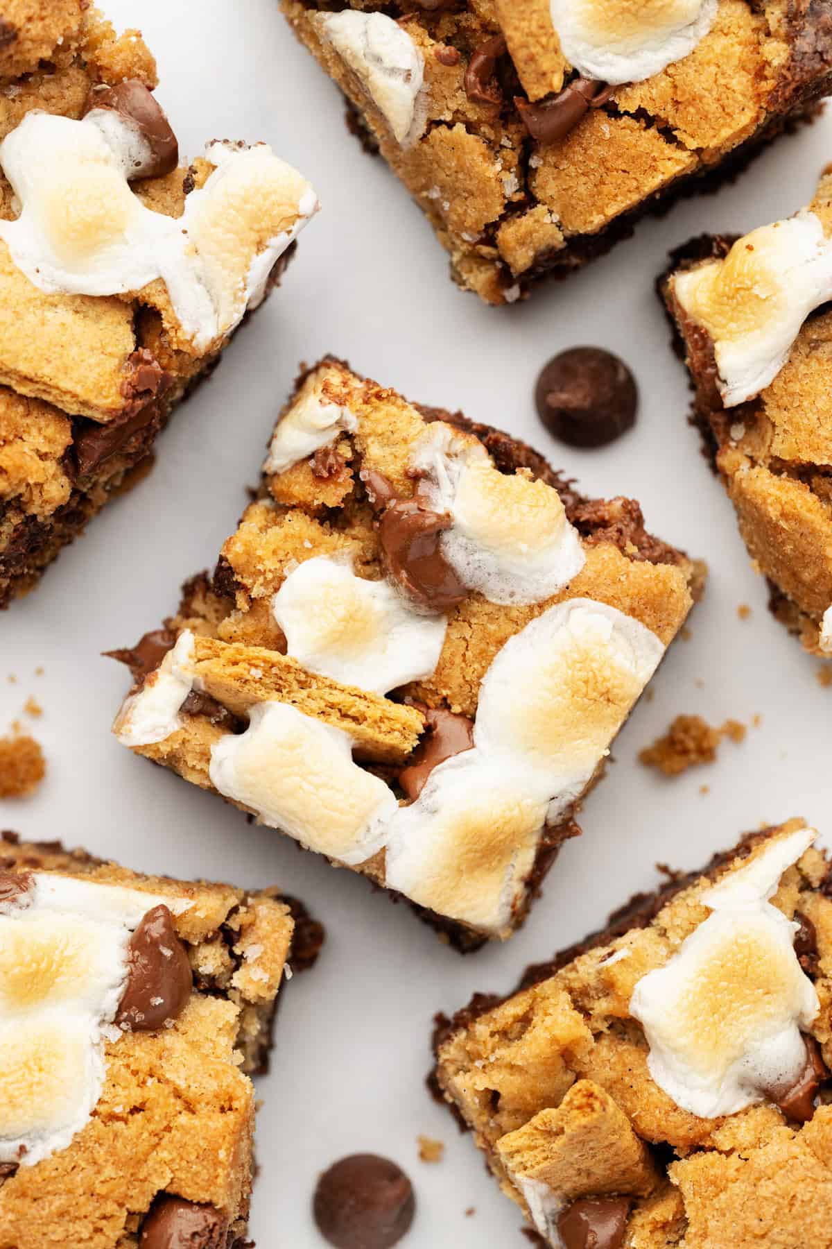 Several S'mores Bars scattered over white background.
