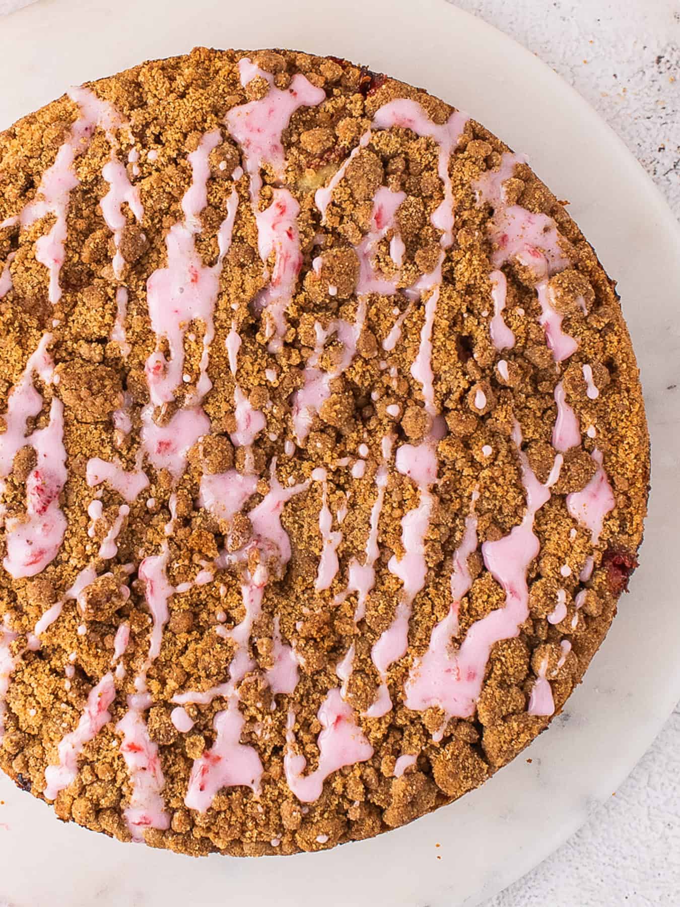 Strawberry Coffee Cake glazed with Strawberry Icing - on a white plate.
