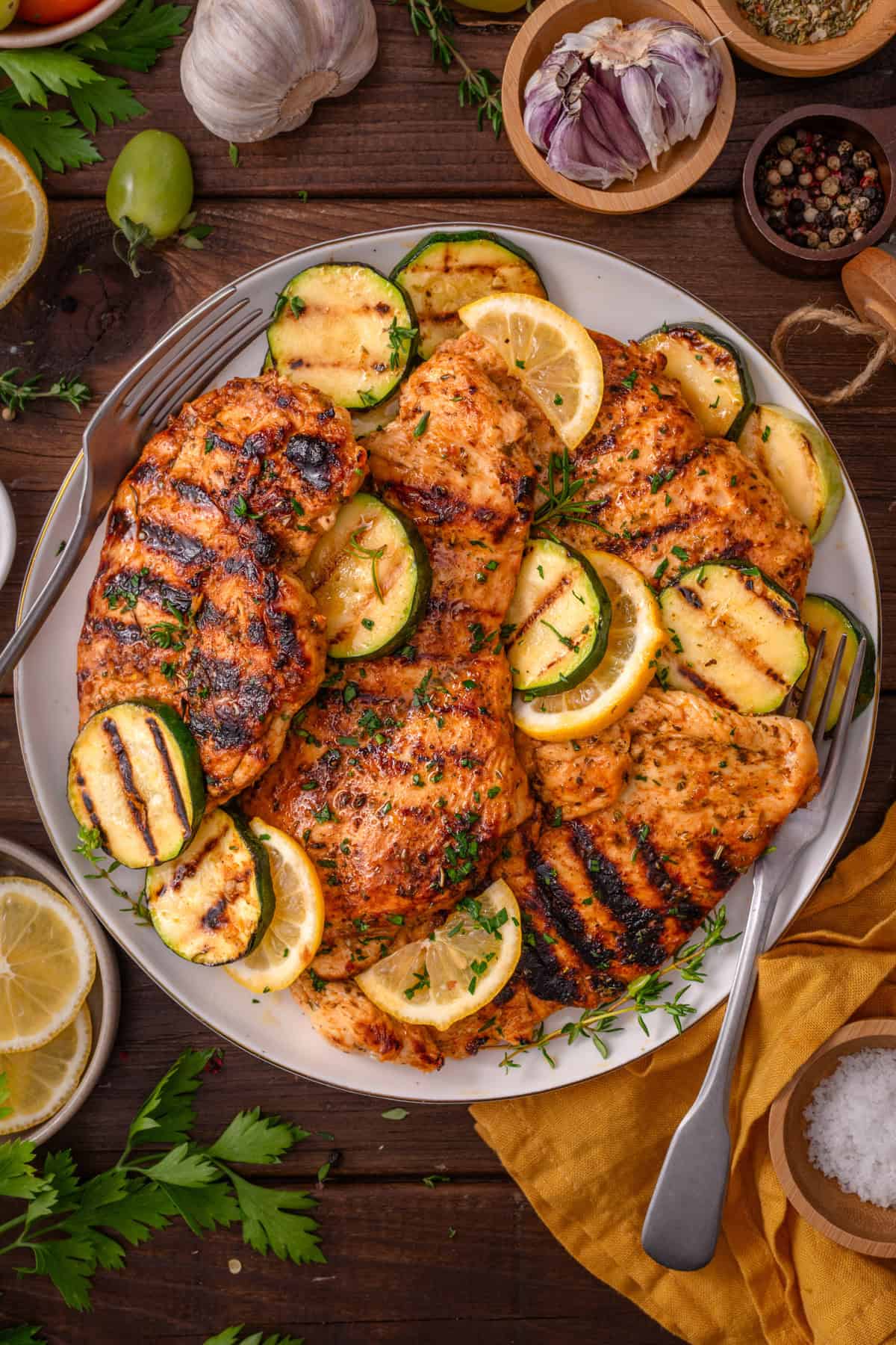 Grilled Chicken Breasts Grilled Chicken Breasts with grilled zucchini rounds on a white plate.