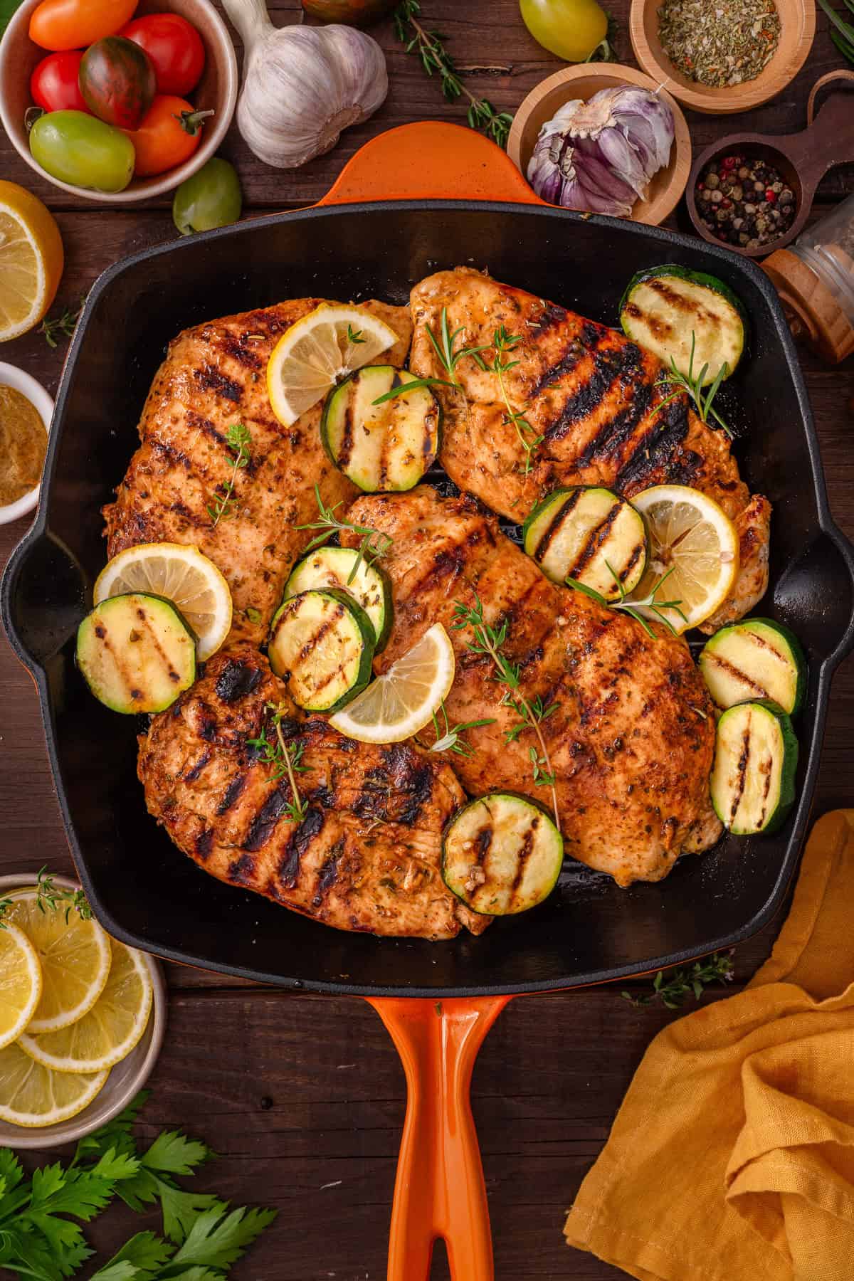 Grilled Chicken Breasts Grilled Chicken Breasts with grilled zucchini rounds in a black cast iron grill pan.