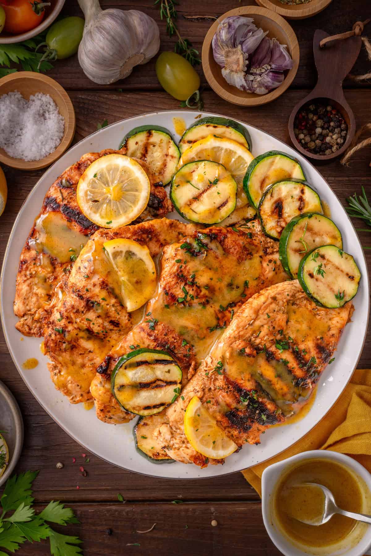 Grilled Chicken Breasts Grilled Chicken Breasts with grilled zucchini rounds on a white plate.