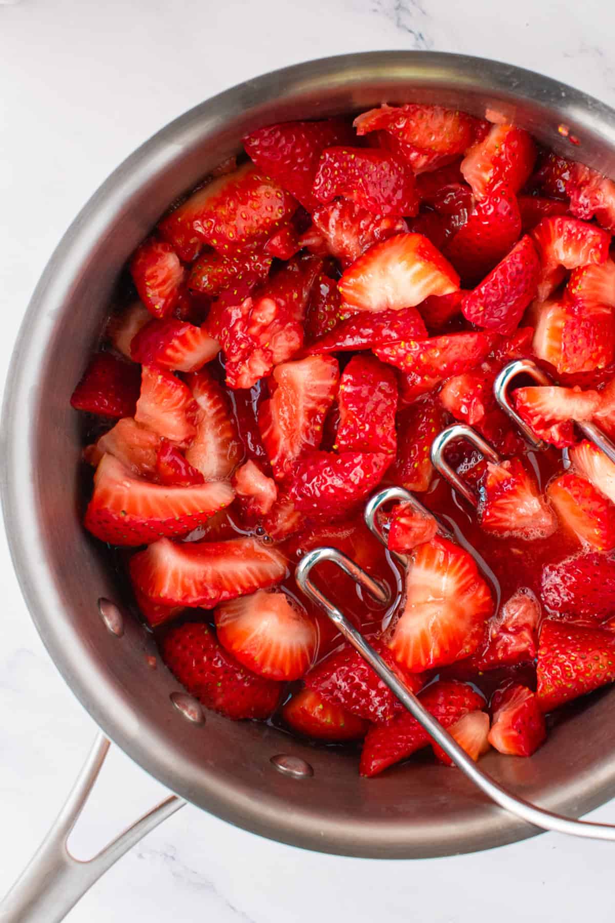 Fresh Strawberries for Tiramisu Sliced fresh strawberries in a pan.