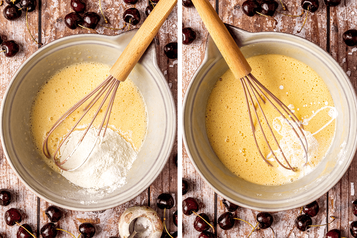Two mixing bowls side by side on a wooden surface, each with a whisk and light yellow batter. The left bowl has flour being mixed in, while the right bowl has milk and cream being added. 