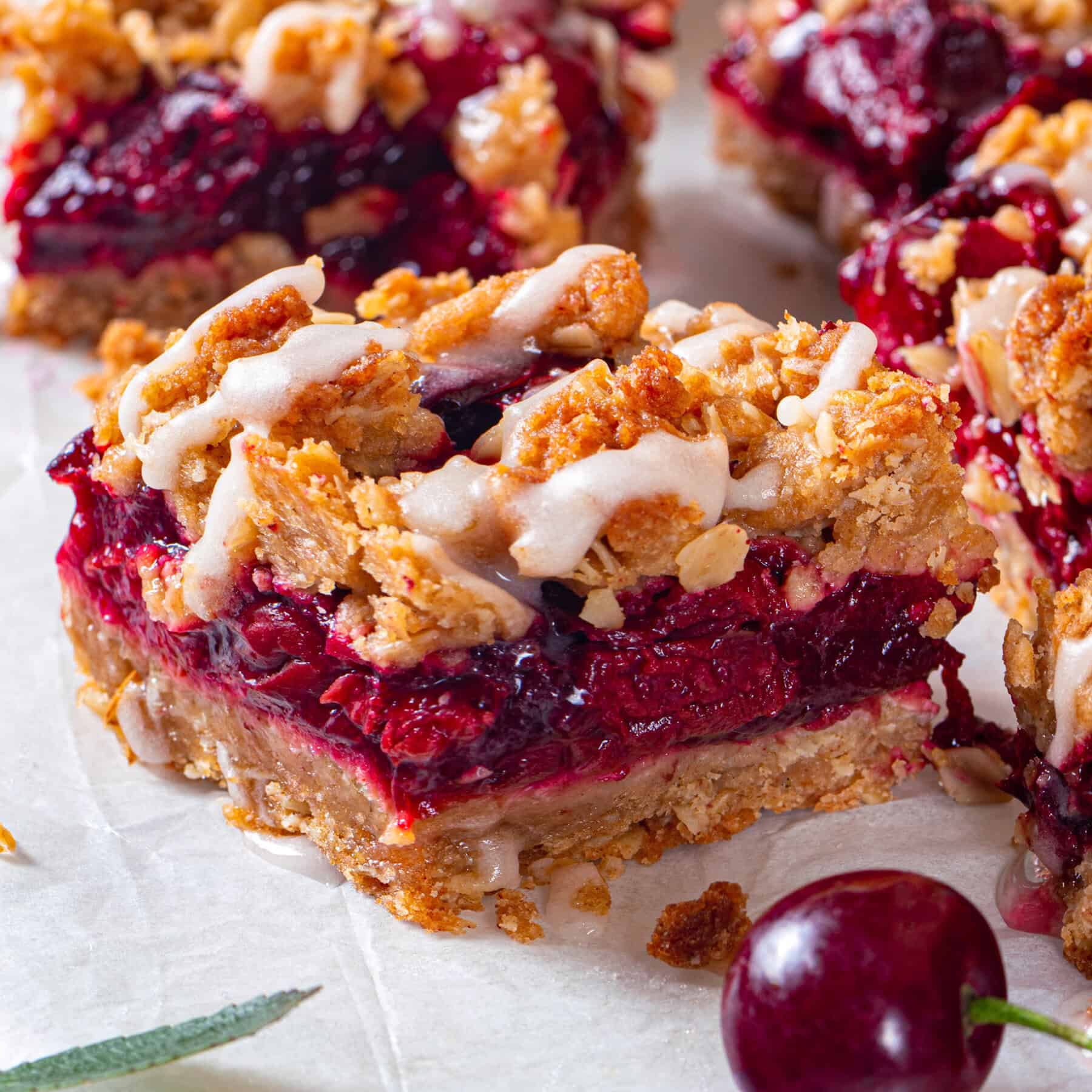 Cherry Pie Bars Cherry Pie Bars with Oat Crust drizzled with Lemon Glaze.