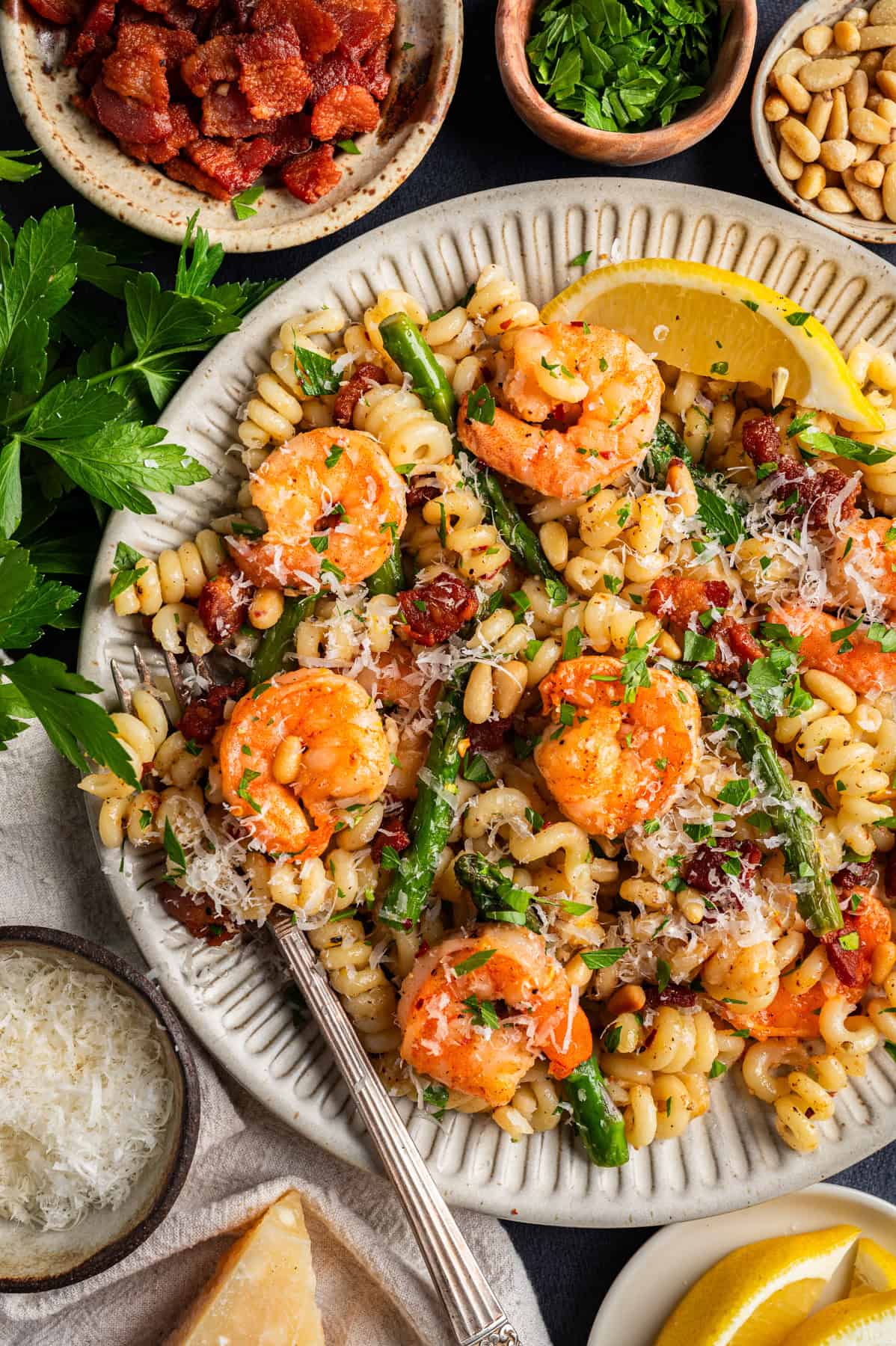 Shrimp Asparagus Pasta with Bacon, Parmesan, and Pine Nuts Shrimp Asparagus Pasta with Bacon, Parmesan, and Pine Nuts - on a white plate.
