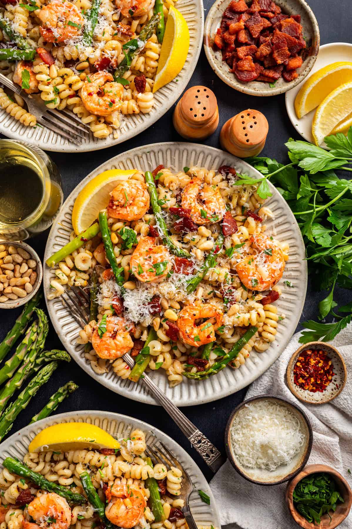 Shrimp Asparagus Pasta with Bacon, Parmesan, and Pine Nuts Shrimp Asparagus Pasta with Bacon, Parmesan, and Pine Nuts - plated on 3 white plates.