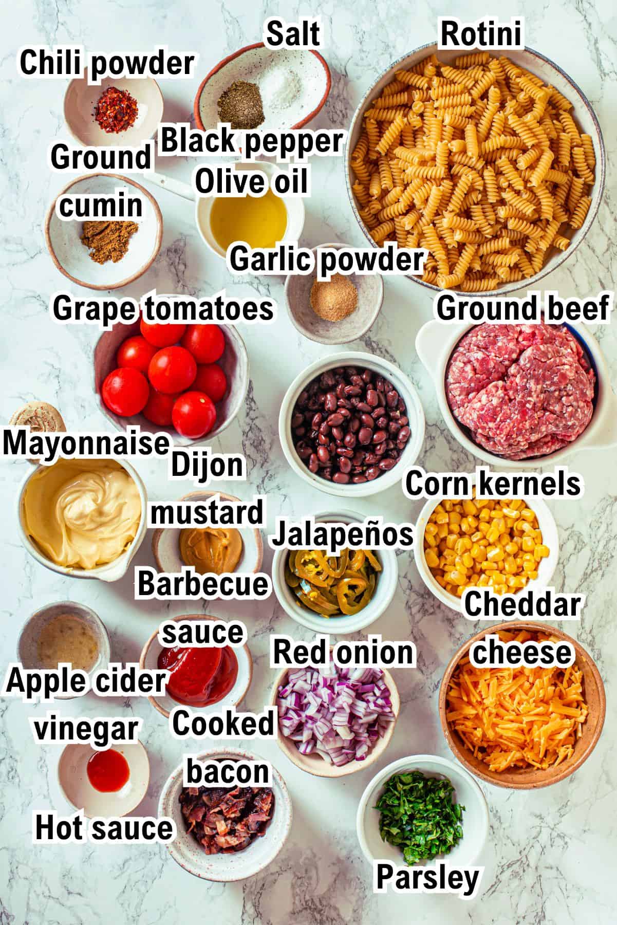 This photo shows all the ingredients needed for the cowboy pasta salad (with labels).