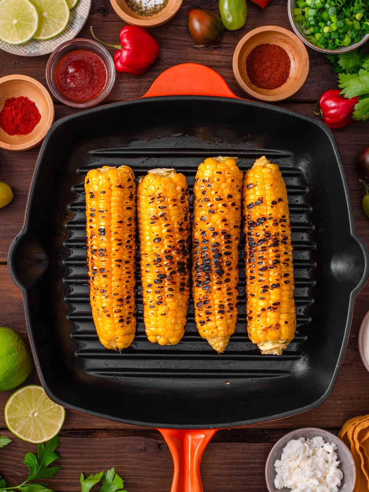 Grilled corn on the cob in a cast iron pan.