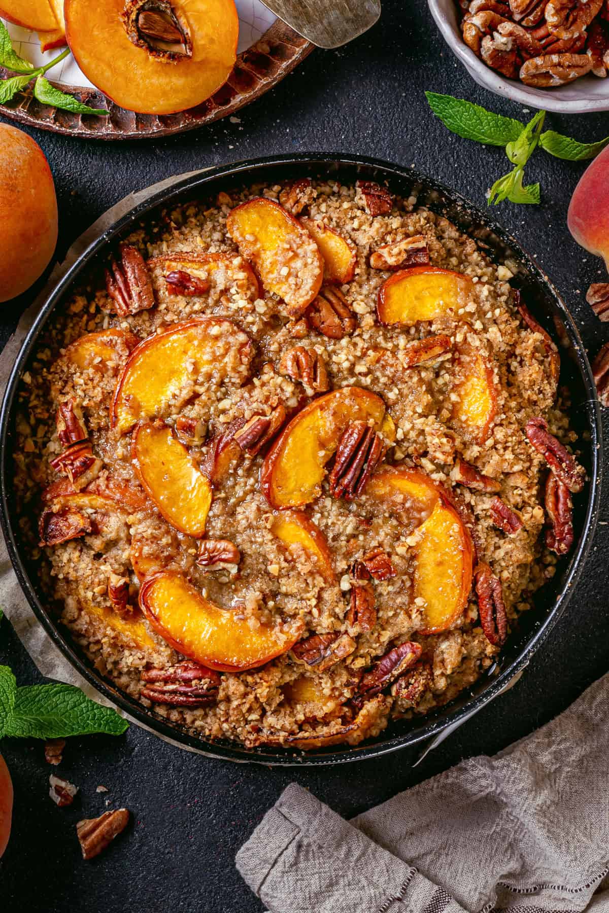 Peach Coffee Cake with Pecan Streusel Peach Coffee Cake topped with Pecan Streusel and Peach Slices - in a springform pan.