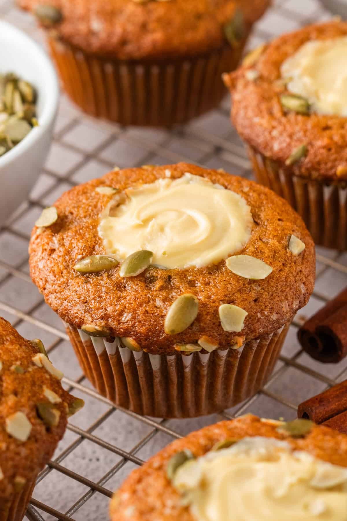 Pumpkin Cream Cheese Muffins Pumpkin Cream Cheese Muffins on a rack.