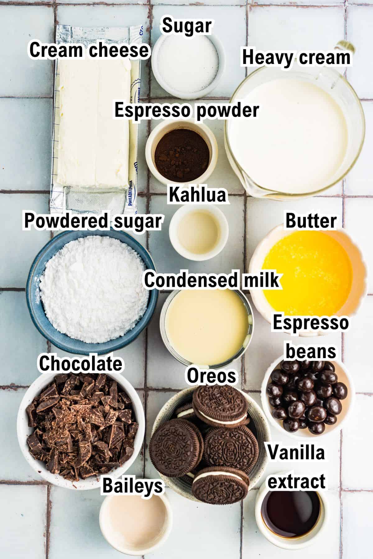 The Ingredients for Mudslide Pie A top-down view of ingredients labeled for a Mudslide pie: cream cheese, sugar, heavy cream, espresso powder, Kahlua, powdered sugar, butter, condensed milk, espresso beans, chocolate, Oreos, Baileys, and vanilla extract.