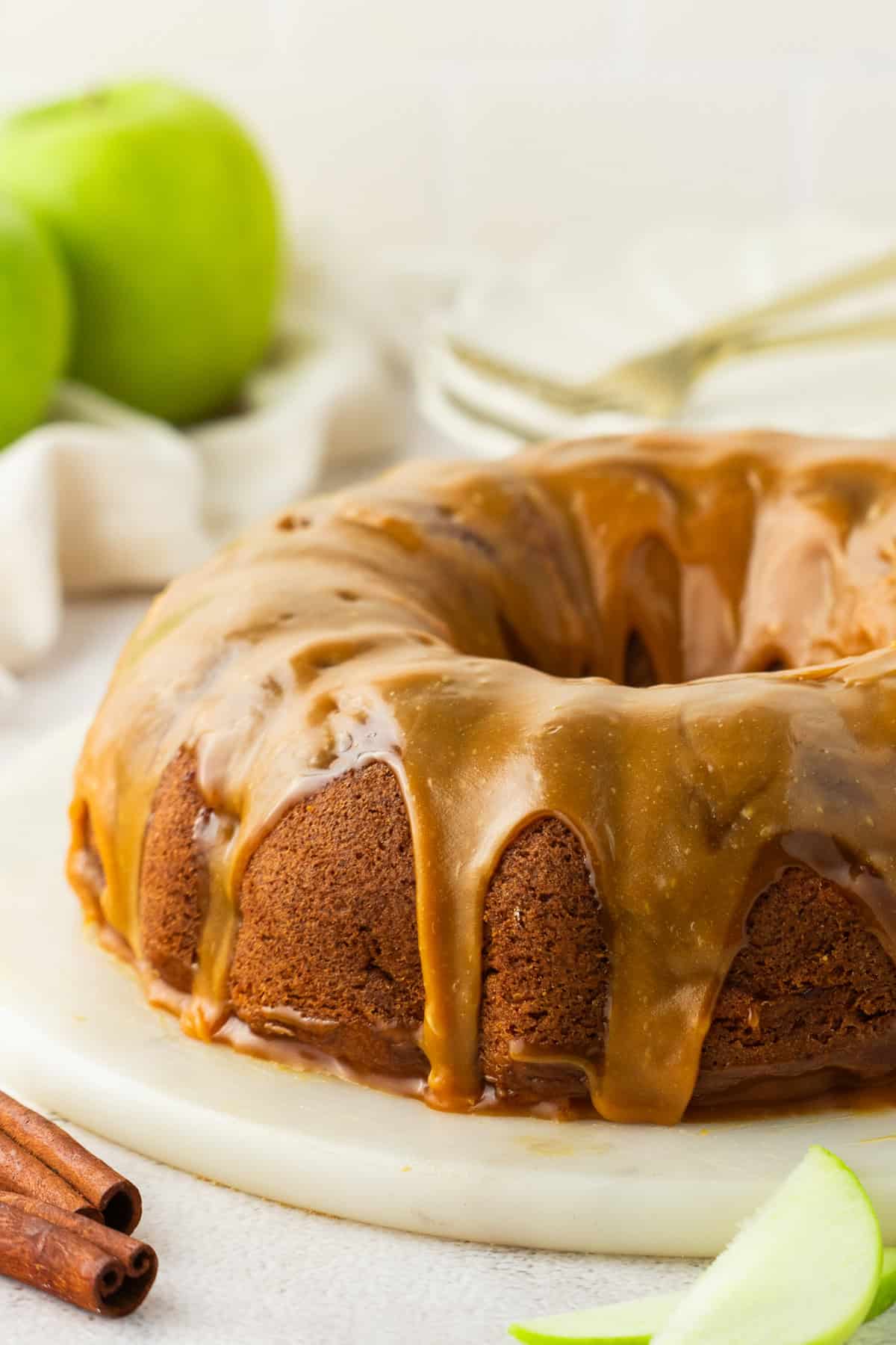 Apple Bundt Cake with Caramel Sauce Apple Bundt Cake with Caramel Sauce on a cake stand.