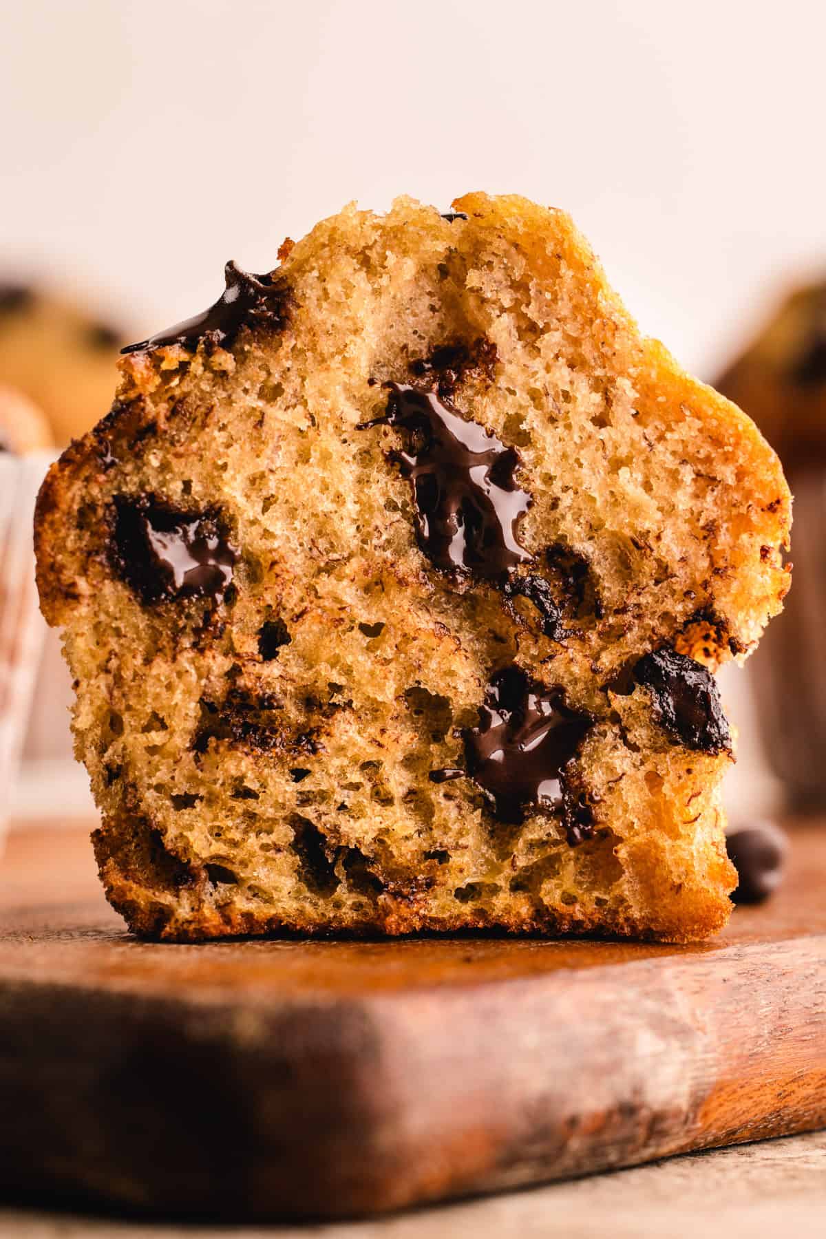 A Banana Chocolate Chip Muffin sliced in half revealing melted chocolate chips.