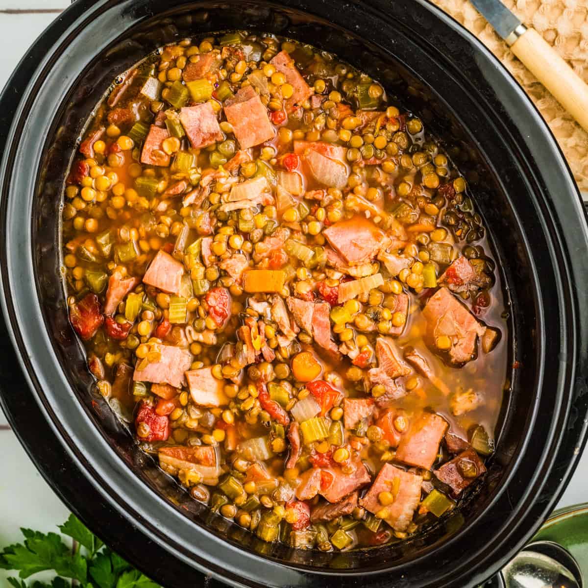 Ham and Lentil Soup in a black slow cooker.