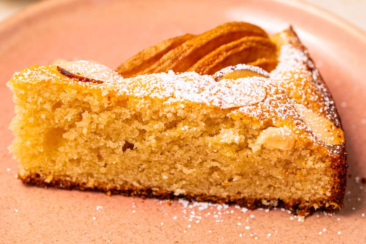 Pear Cake with Almond Flour, Almonds, and Fresh Pears A slice of pear cake on a plate.