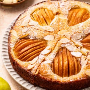 Pear Cake with Almond Flour, Almonds, and Fresh Pears - on a large plate.