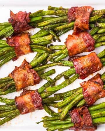 Green Bean Bundles Wrapped in Bacon - on a white background.