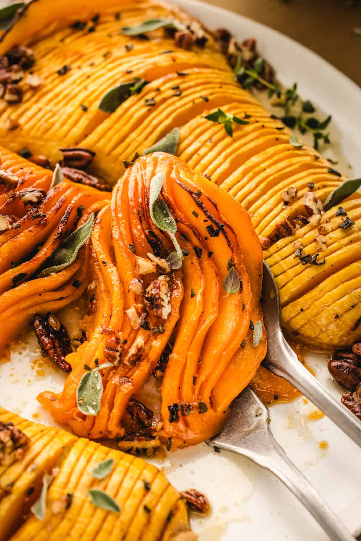 Hasselback Butternut Squash (2 squash halves on a white platter).