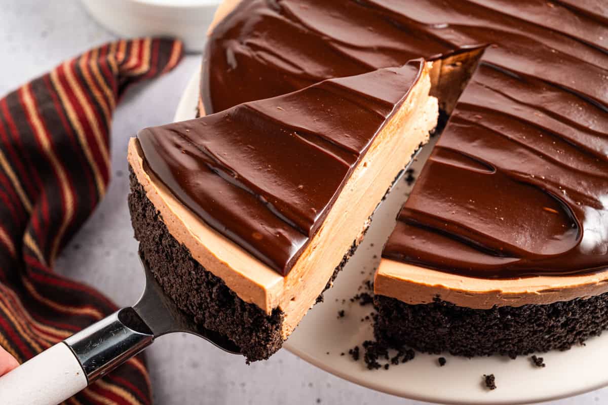 A slice of Mocha Cheesecake on a pie spatula lifted out of the cake.