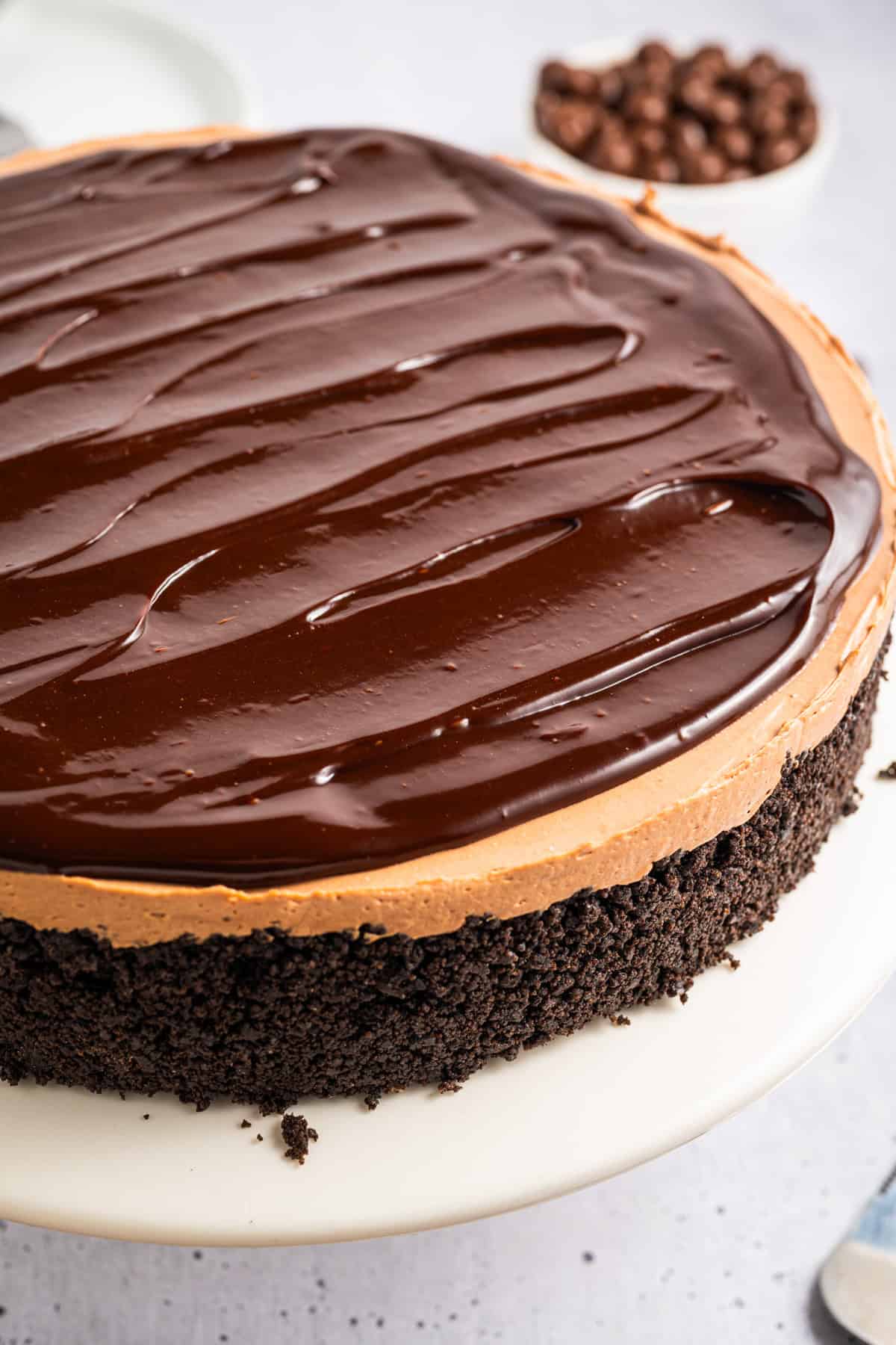 Mocha Cheesecake (side view) on a white cake platter.