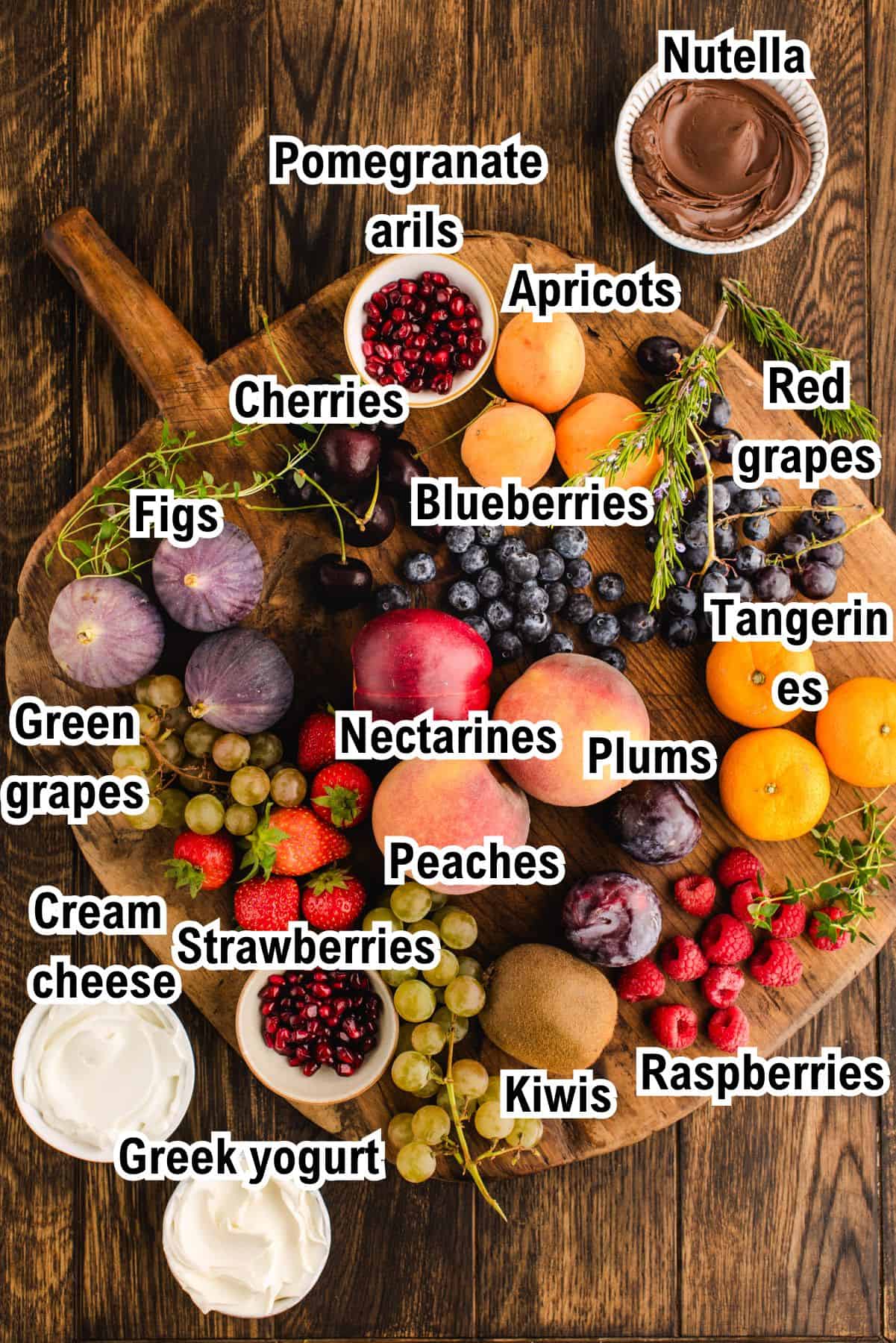 The Ingredients for Fruit Platter with Nutella Dip This photo shows The Ingredients for a Fruit Platter with Nutella Dip - on a wooden background.