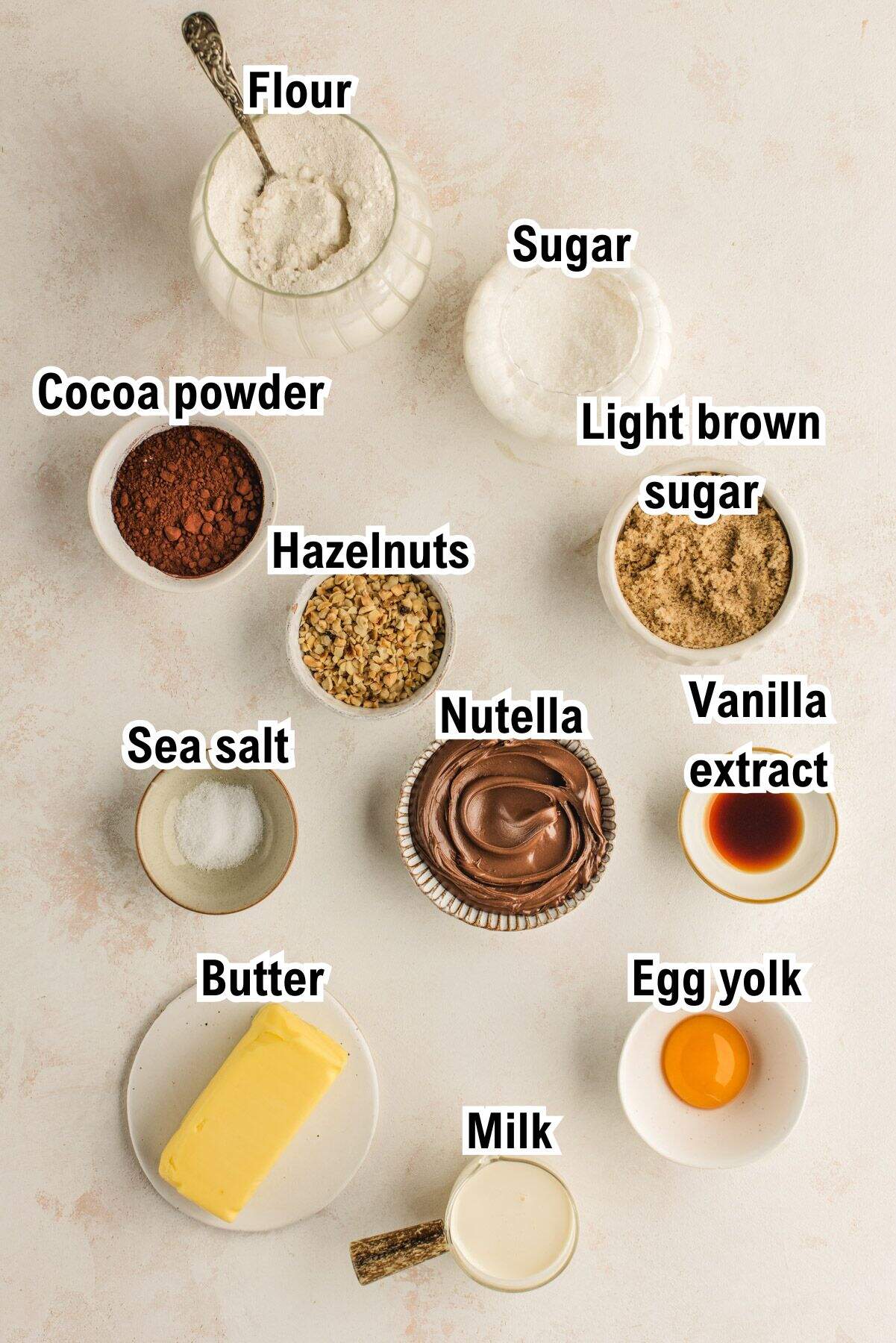 The Ingredients for Chocolate Hazelnut Thumbprint Cookies This photo shows all the ingredients for Chocolate Hazelnut Thumbprint Cookies (labeled).