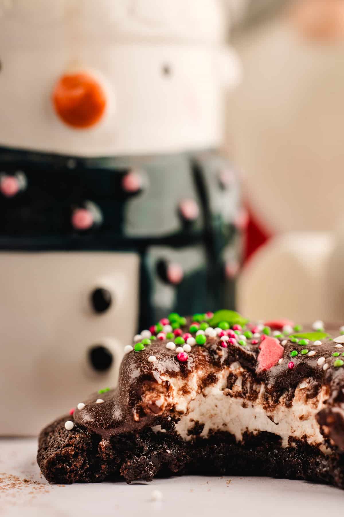 Hot Cocoa Cookies Hot Cocoa Cookie (with a bite out) in front of a Christmas mug.