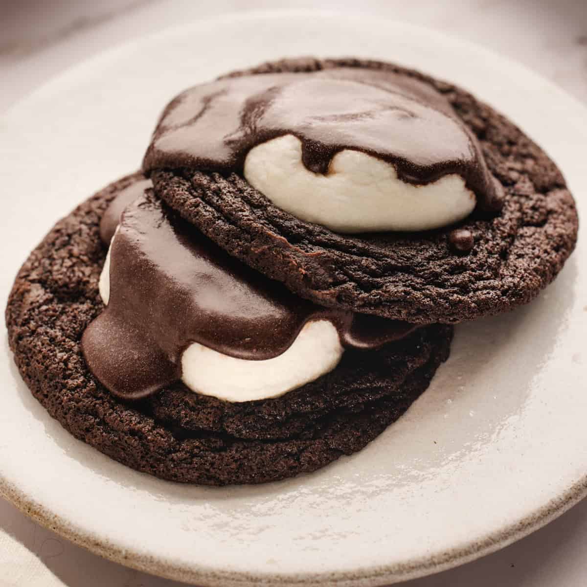 Hot Cocoa Cookies 2 Hot Cocoa Cookies with Marshmallows on a small plate.