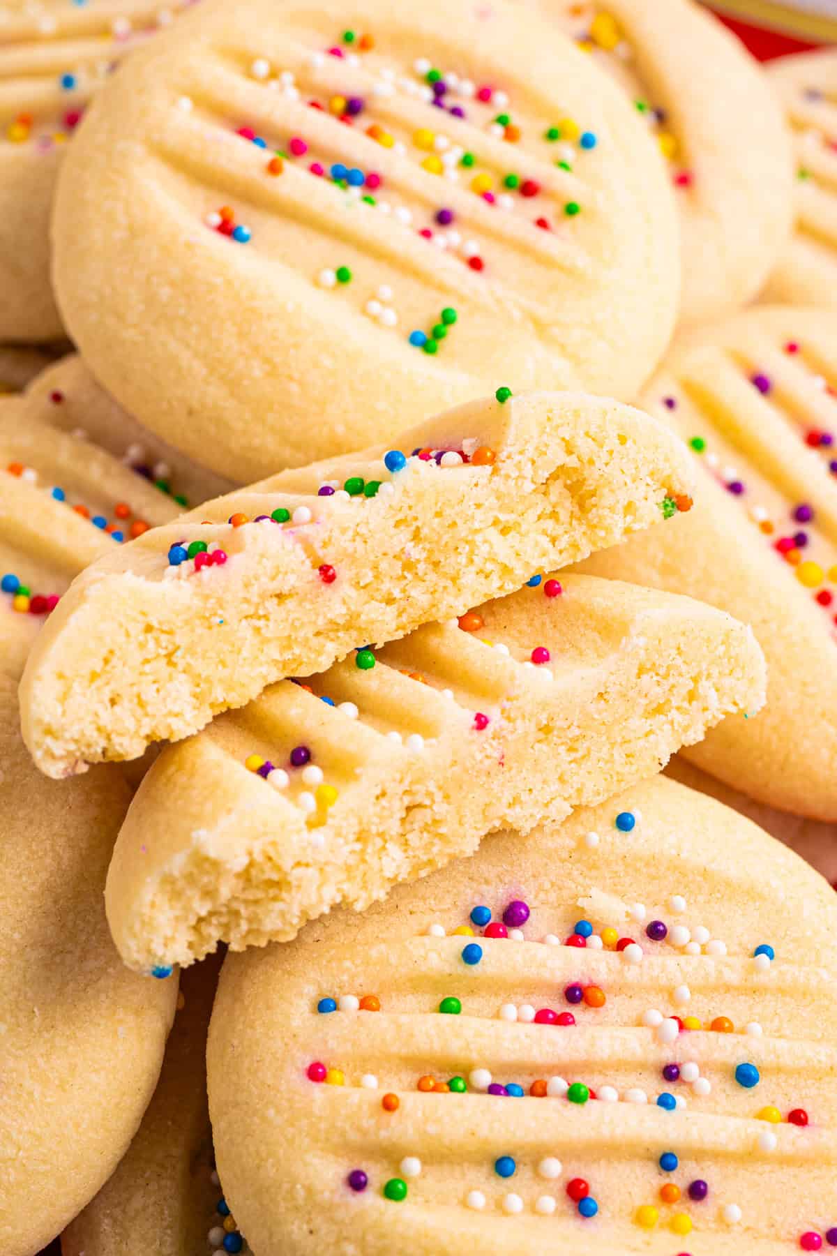 Whipped Shortbread Cookies with sprinkles - on a white plate.
