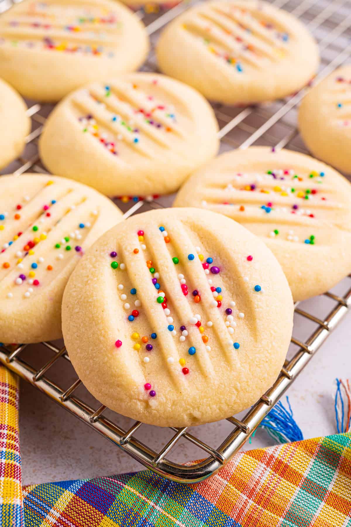 Whipped Shortbread Cookies with sprinkles - on a rack.