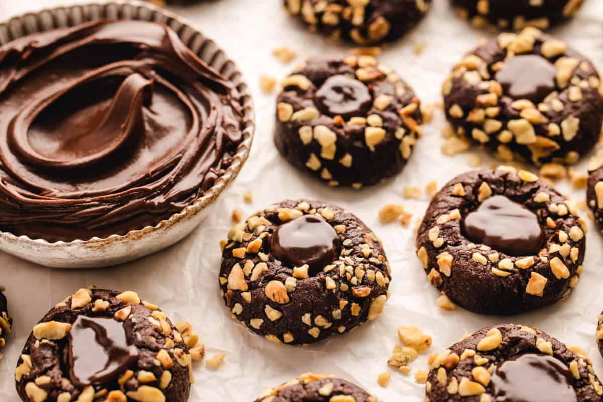 Chocolate Hazelnut Thumbprint Cookies Chocolate Hazelnut Thumbprint Cookies with the Nutella in a bowl - on a white background.