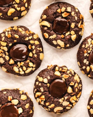 Chocolate Hazelnut Thumbprint Cookies on a white background.