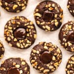 Chocolate Hazelnut Thumbprint Cookies on a white background.