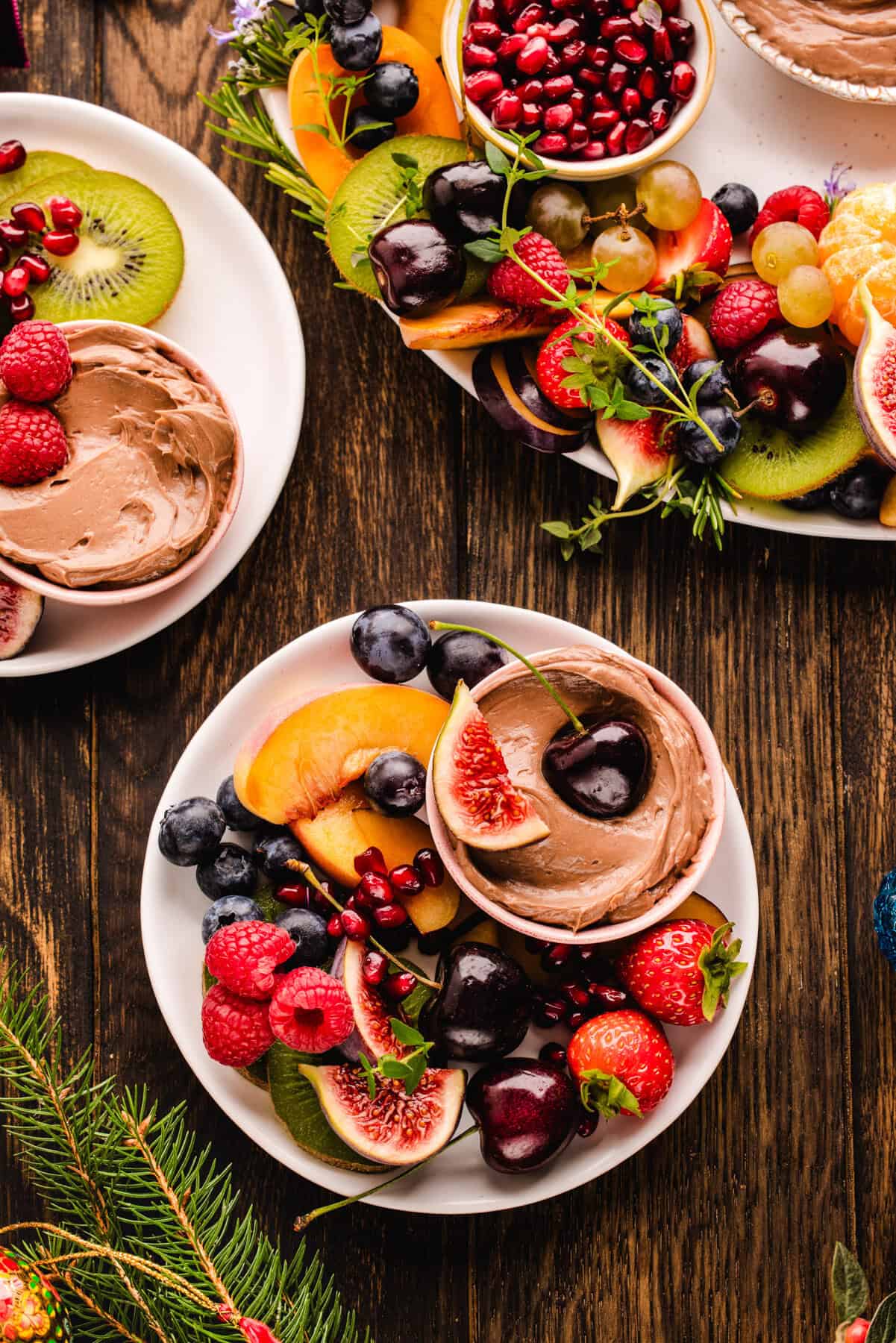 Fruit Platter with Nutella Dip Assorted fruit on a small plate with the small bowl of Nutella dip, with a larger fruit wreath platter in the background