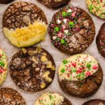 Ginger molasses cookies (some covered with white chocolate, some with dark chocolate, topped with sprinkles or crystallized ginger) - on a white background.