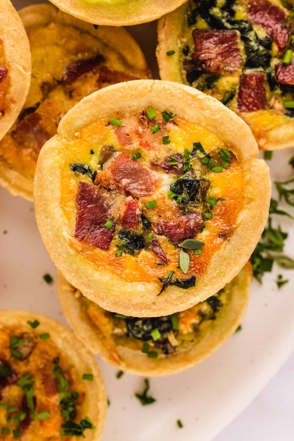 Mini Quiches (filled with cheese, eggs, bacon, spinach).