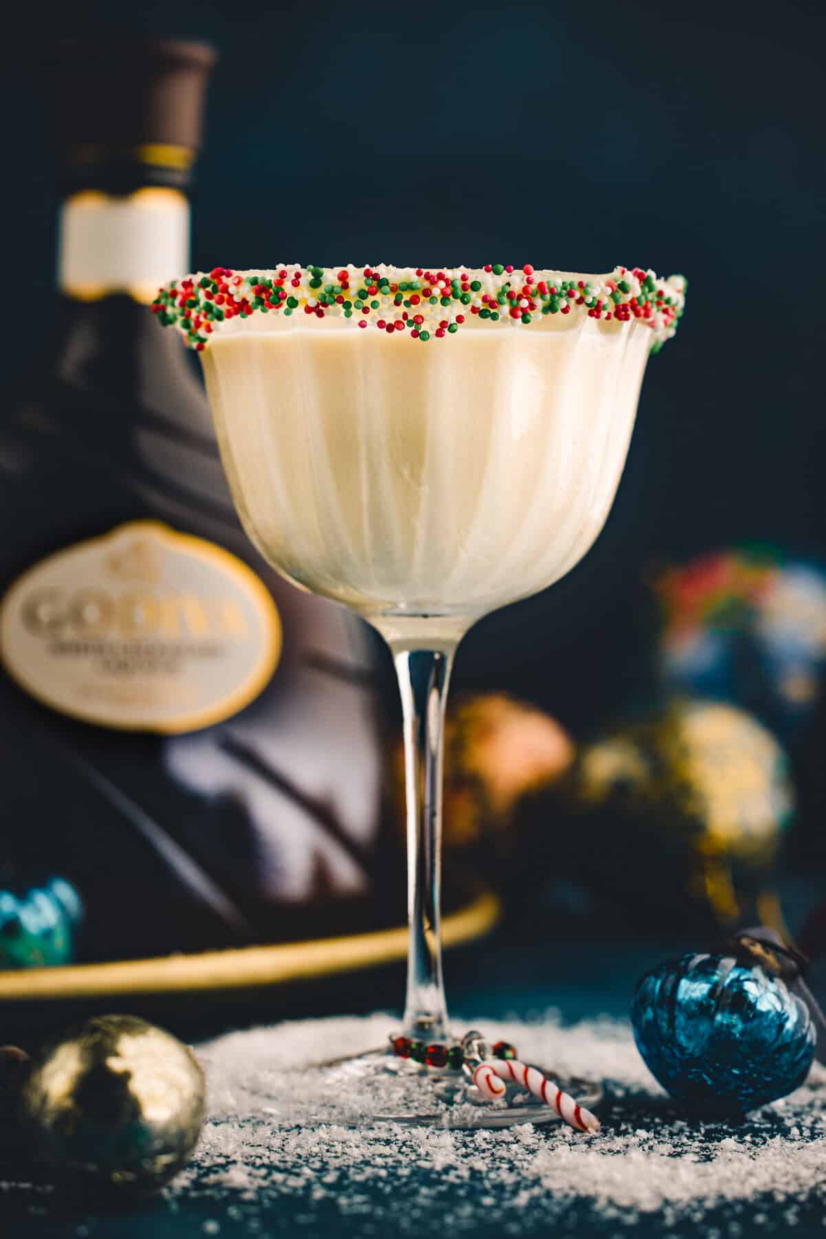 Sugar Cookie Martini (with festive holiday sprinkles around the rim of the martini glass).