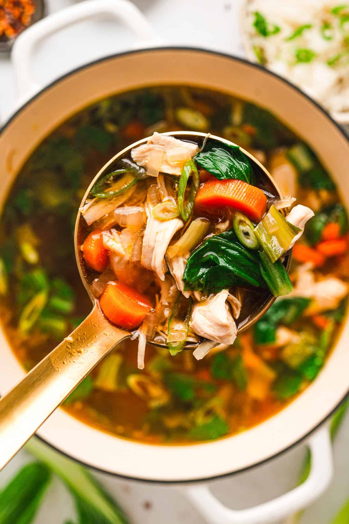 Asian Chicken and Rice Soup The close-up of the ladle of Asian Chicken and Rice Soup over the soup pot.