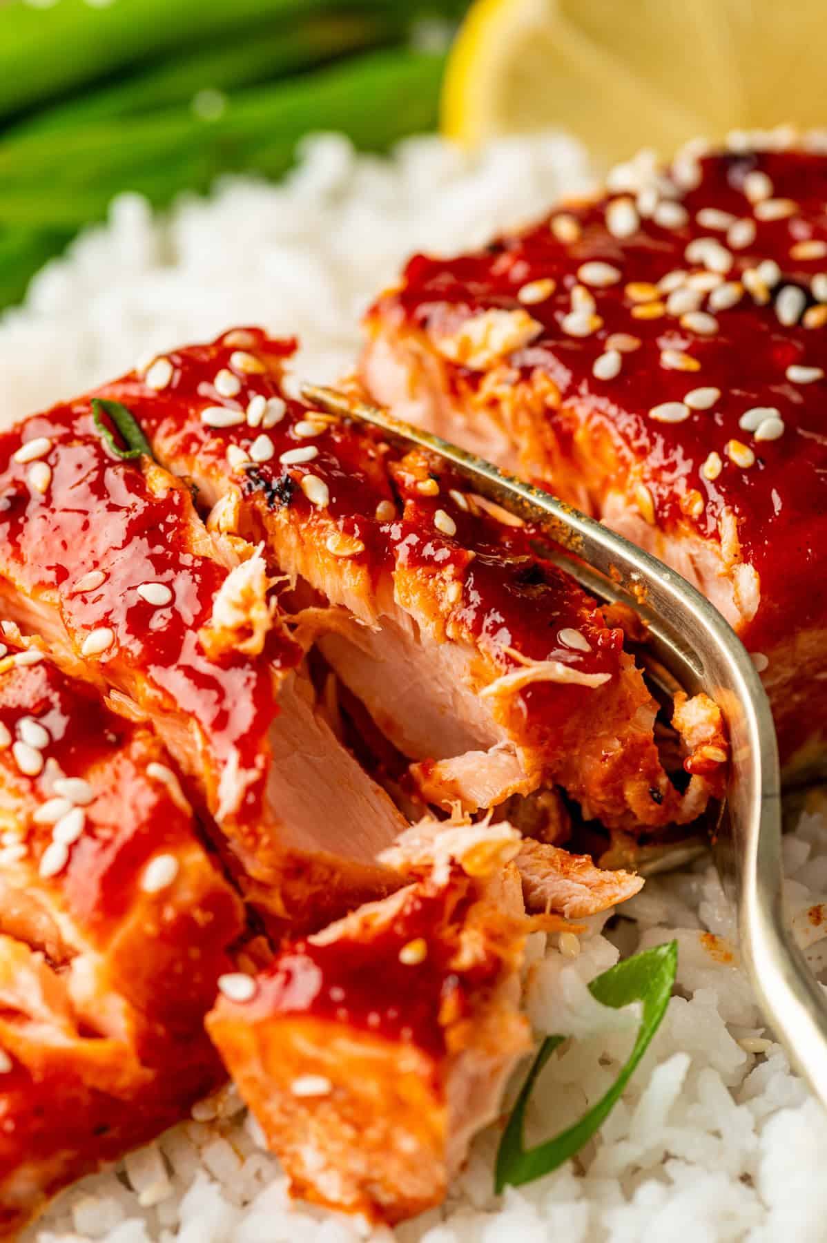 Delicious Korean-style salmon glazed with spicy gochujang sauce, atop rice, garnished with sesame seeds.