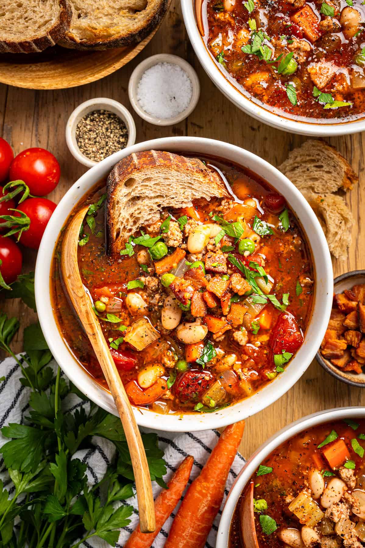 Ground Turkey Soup with Carrots, Peas, Beans, Bacon, Tomatoes, Herbs - in a bowl.