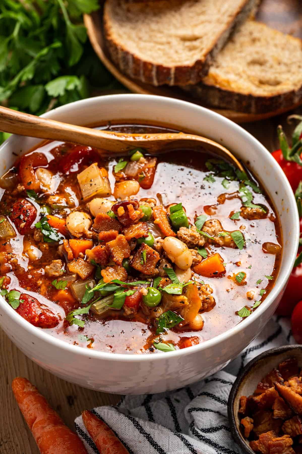 Ground Turkey Soup with Carrots, Peas, Beans, Bacon, Tomatoes, Herbs in a bowl.