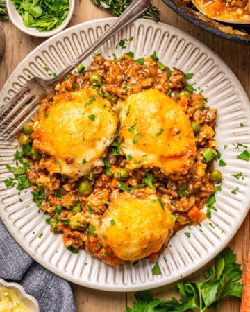 A portion of Shepherd's Pie (topped with mashed potatoes tiled as "domes") - on a small white plate.