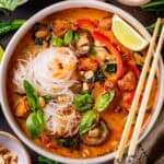 Thai chicken curry soup (with noodles, red bell peppers, and mushrooms) - in a bowl.