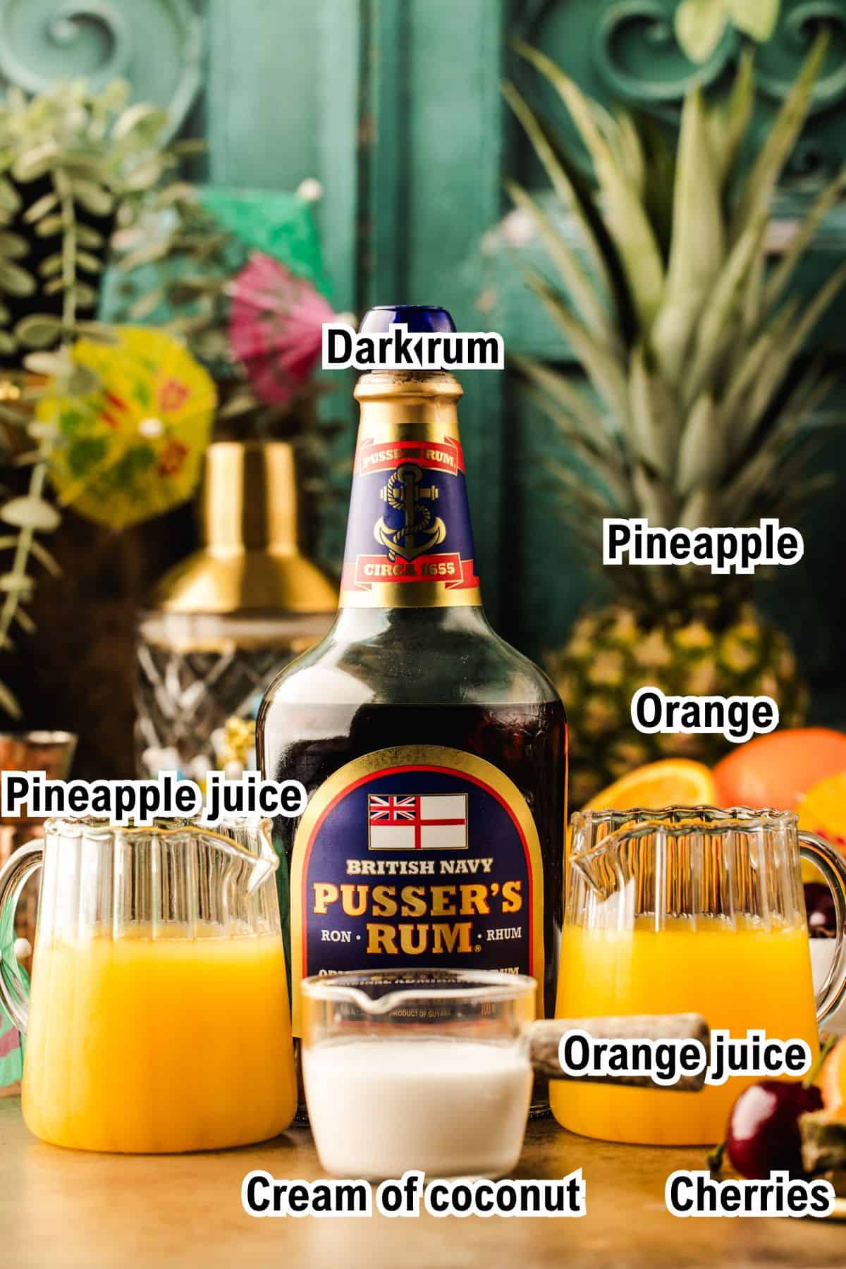 The Ingredients for Painkiller Cocktail A bottle of Pusser's Rum is surrounded by labeled ingredients for Painkiller Cocktail: pineapple, pineapple juice, orange, orange juice, cream of coconut, and cherries, with a green decorative background and cocktail shaker visible.