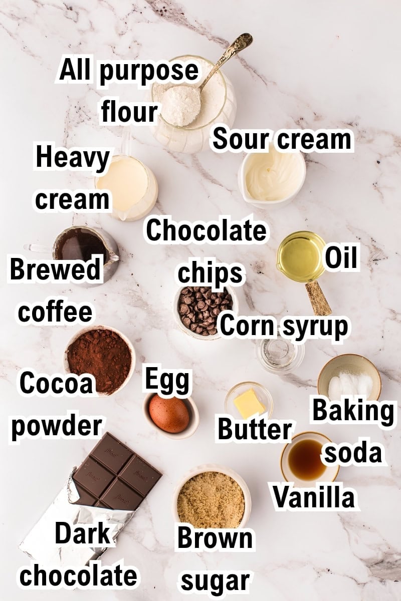 The Ingredients for Double Chocolate Loaf Cake This photo shows the ingredients for Chocolate Loaf Cake: all-purpose flour, heavy cream, brewed coffee, cocoa powder, dark chocolate, sour cream, chocolate chips, egg, butter, brown sugar, corn syrup, oil, baking soda, and vanilla.