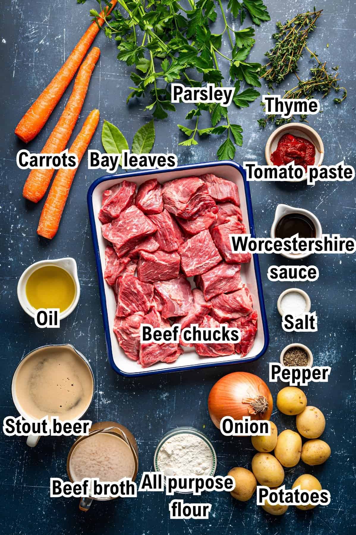 The Ingredients for Irish Beef Stew This photo shows the ingredients for Irish Beef Stew: raw beef chunks, carrots, potatoes, onion, parsley, thyme, bay leaves, tomato paste, Worcestershire sauce, oil, salt, pepper, stout beer, beef broth, and flour.